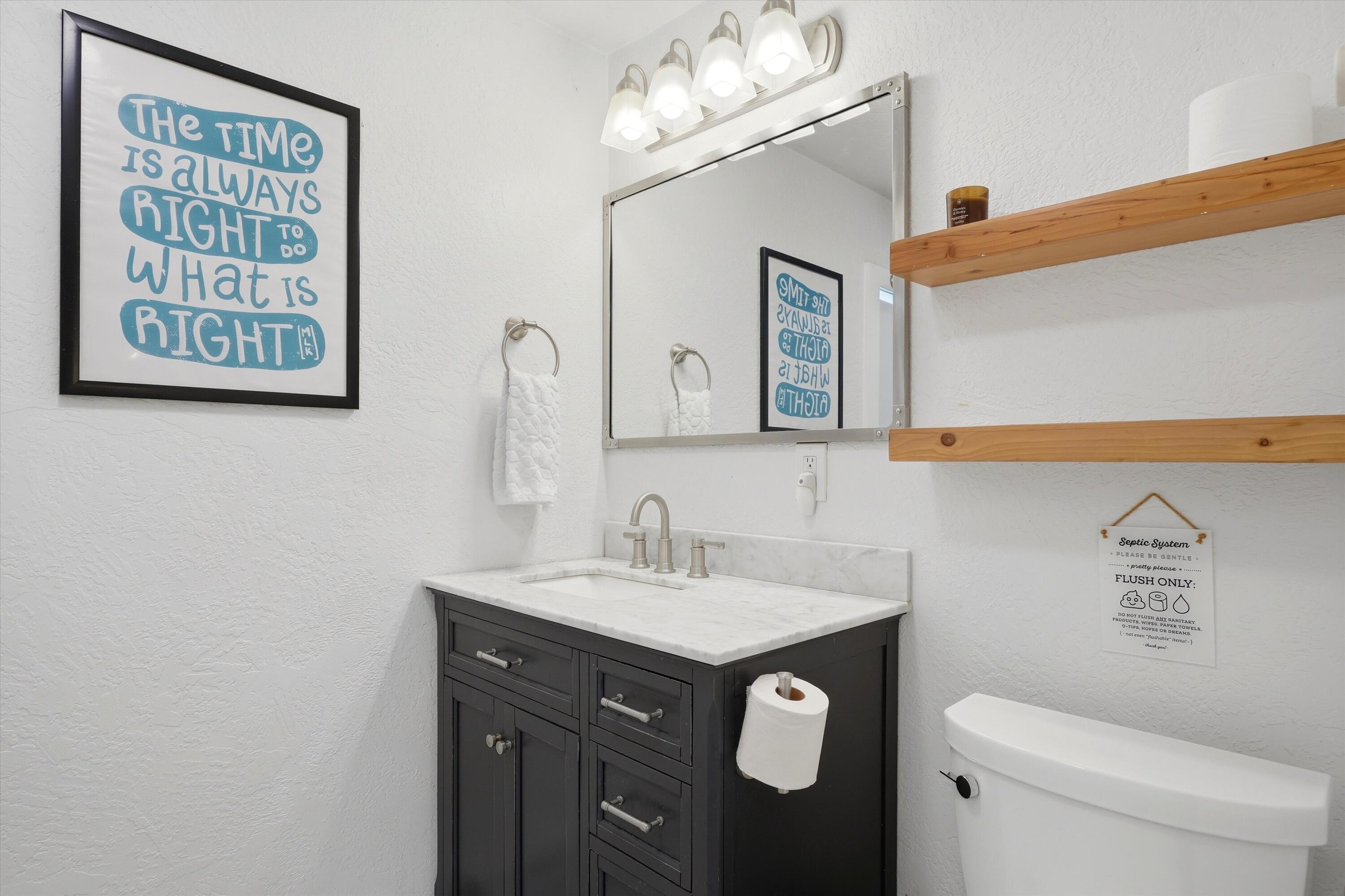 61280 Larsen Road Bend, OR 97702 - Photo 25 of 58 a bathroom with a sink a mirror and a toilet
