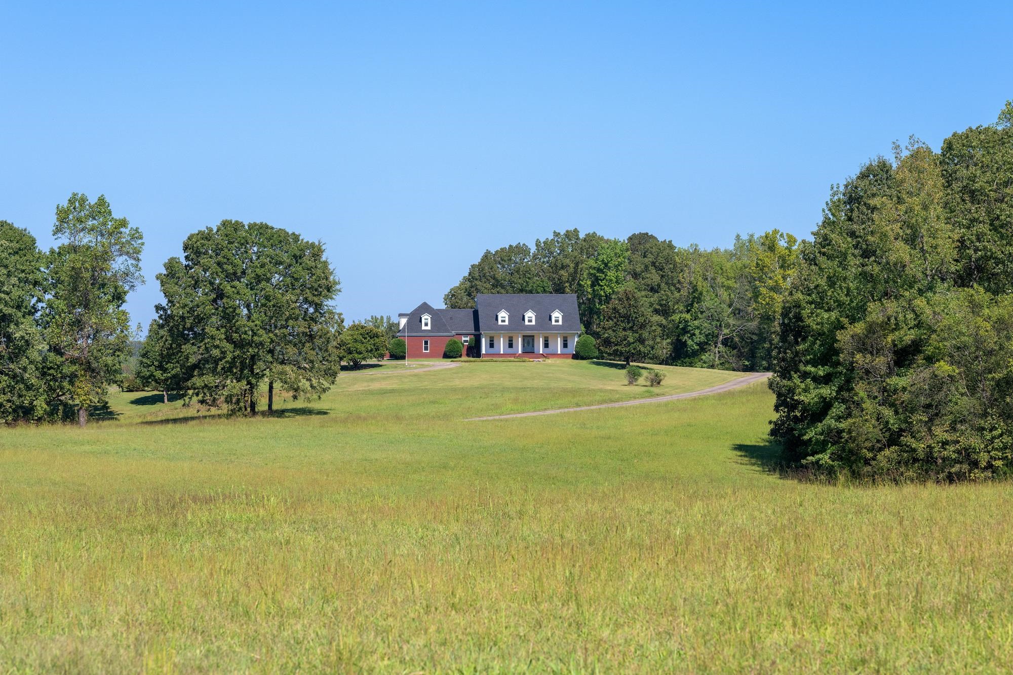 599 DT Vise Loop Parsons, TN 38363 - Photo 2 of 40 View of grassy front yard with a view of countryside and a forest view