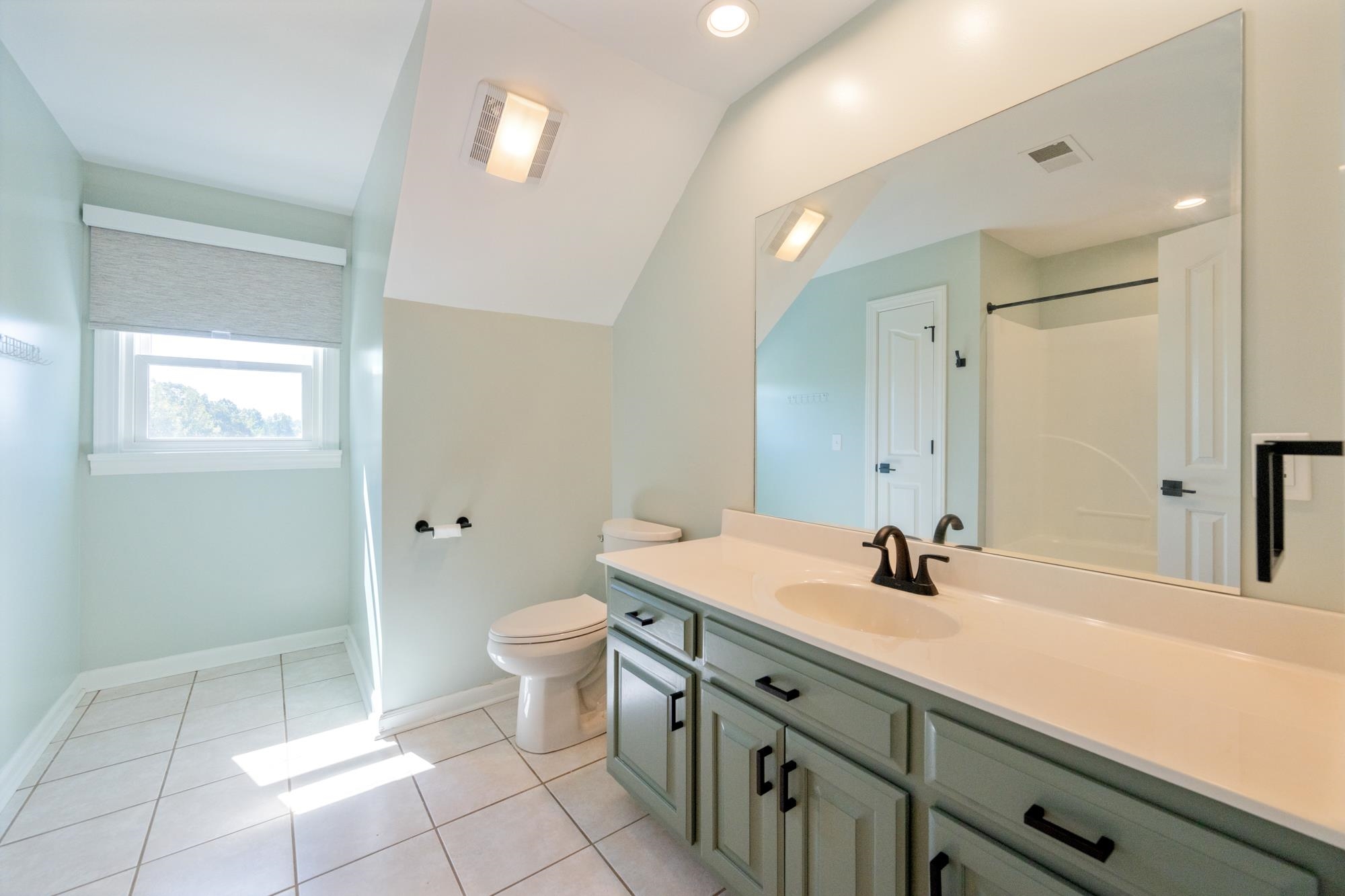 599 DT Vise Loop Parsons, TN 38363 - Photo 27 of 40 Full bathroom with vanity, light tile patterned floors, vaulted ceiling, a shower, and recessed lighting