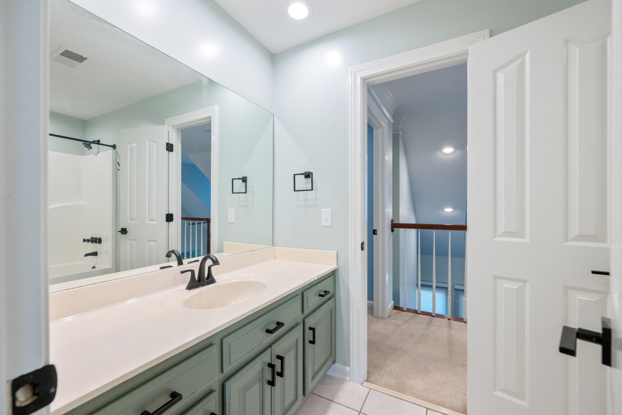 599 DT Vise Loop Parsons, TN 38363 - Photo 30 of 40 Bathroom featuring shower / tub combination, vanity, light colored carpet, recessed lighting, and light tile patterned flooring