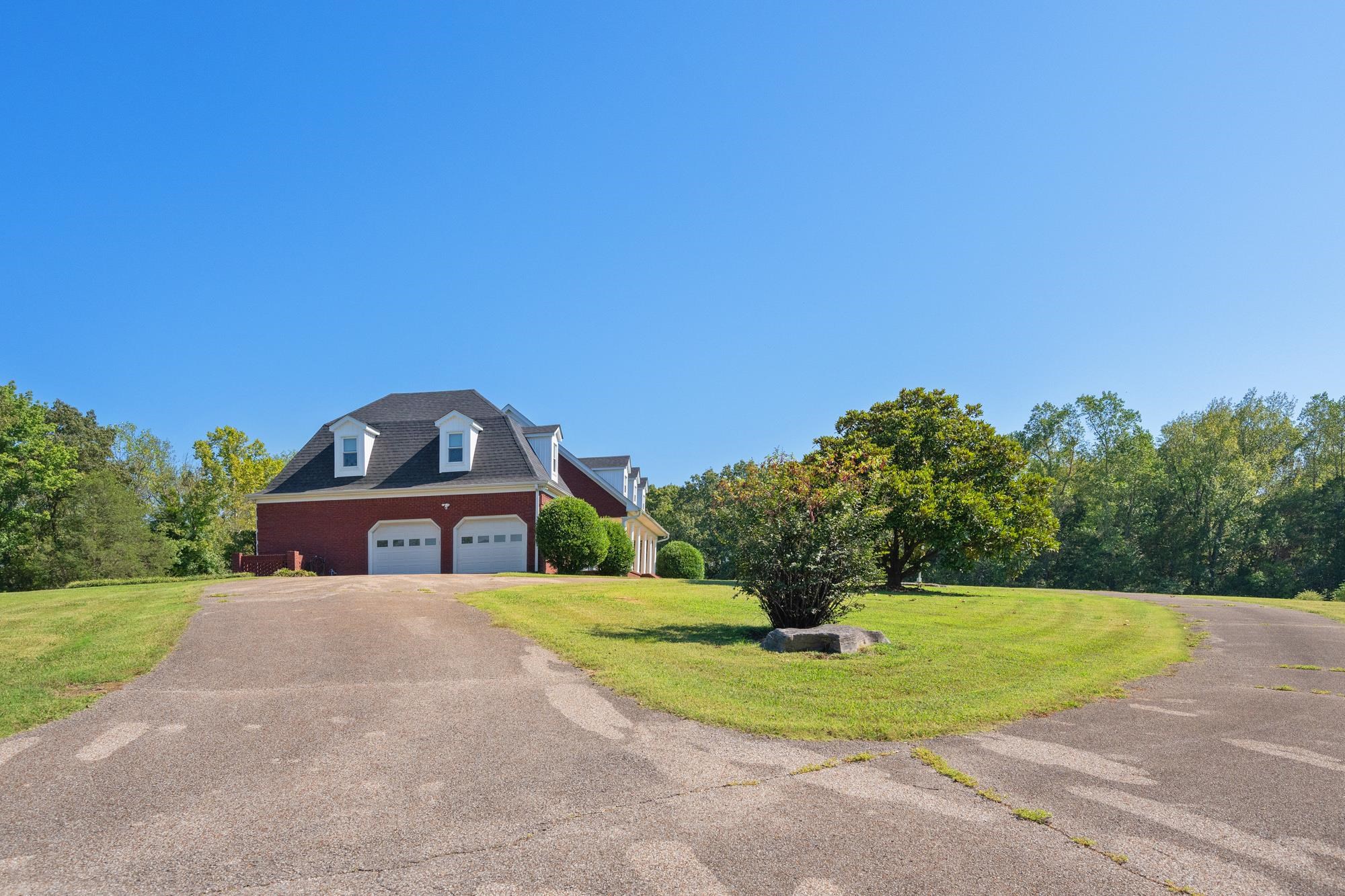599 DT Vise Loop Parsons, TN 38363 - Photo 37 of 40 View of front of property with asphalt driveway, a front lawn, and a garage