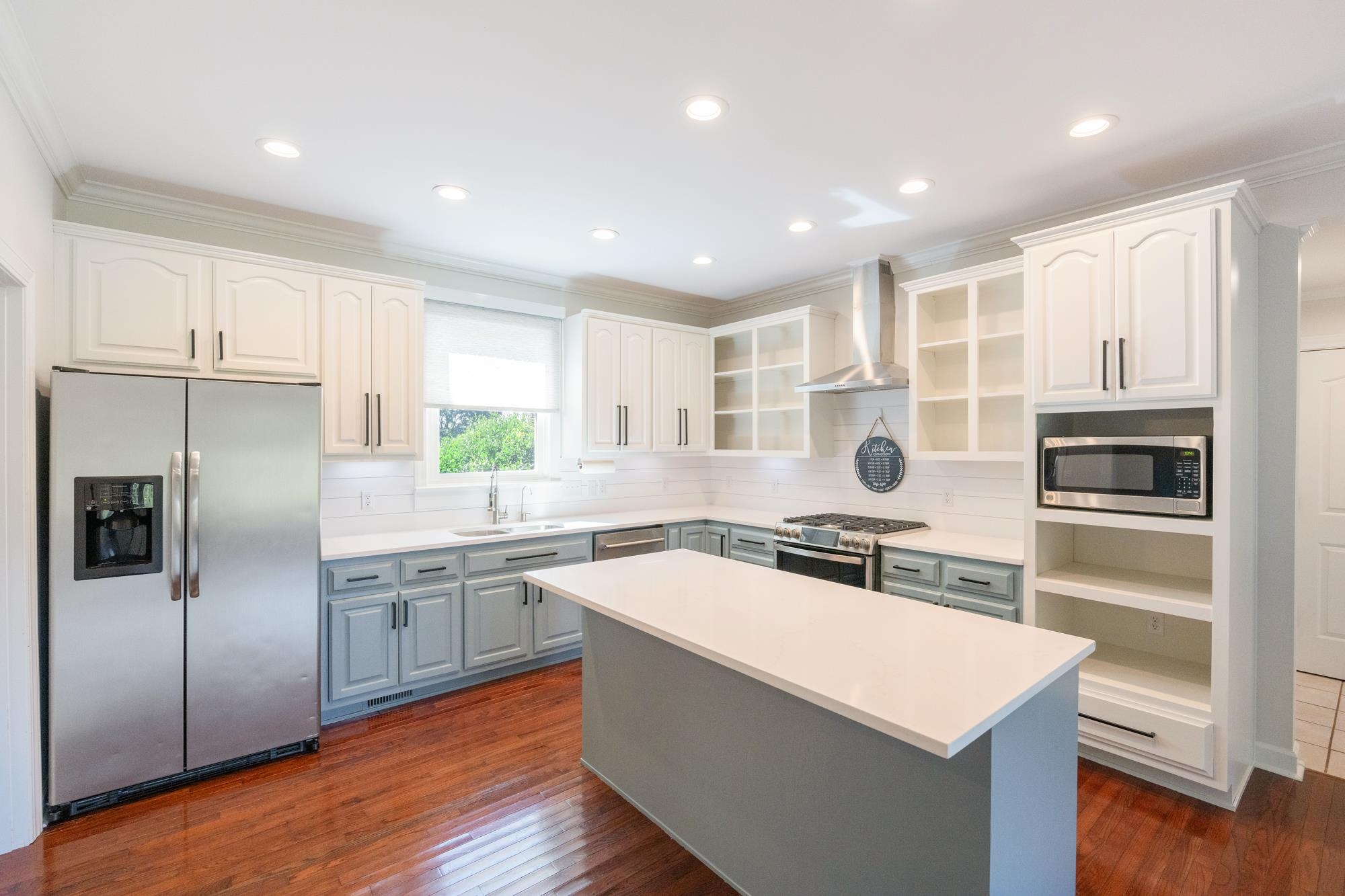 599 DT Vise Loop Parsons, TN 38363 - Photo 9 of 40 Kitchen with appliances with stainless steel finishes, ornamental molding, recessed lighting, backsplash, and wall chimney range hood