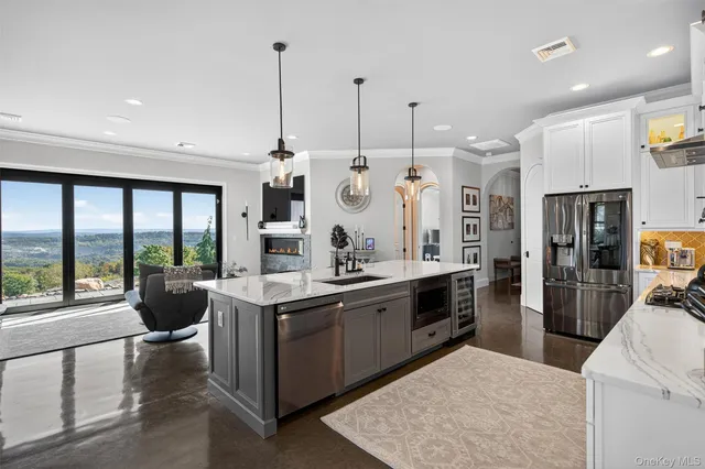 a kitchen with stainless steel appliances granite countertop a stove and more cabinets
