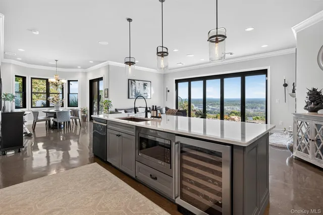 a large kitchen with a large window and stainless steel appliances