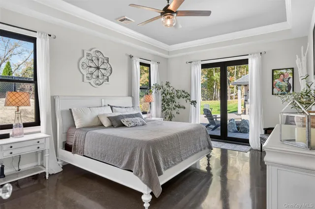 a bedroom with a large bed and a chandelier
