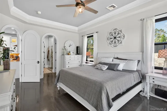 a bedroom with a large bed and a chandelier