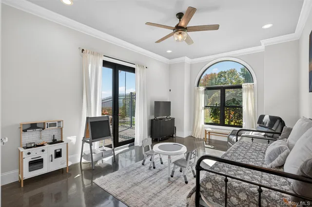 a living room with furniture fireplace and a large window