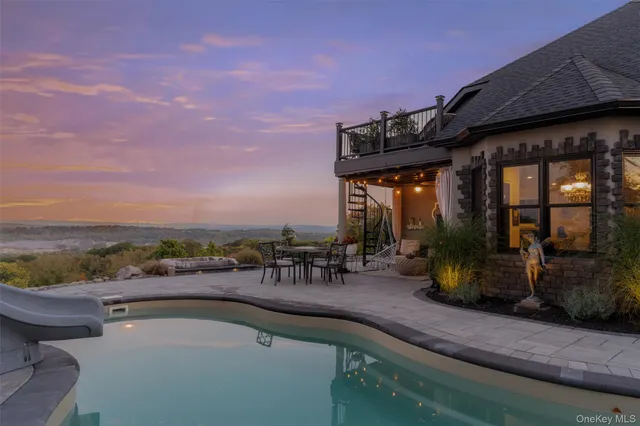 an outdoor view of house with yard and seating area