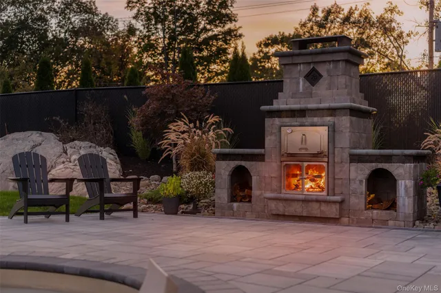 a view of a chairs and table in backyard