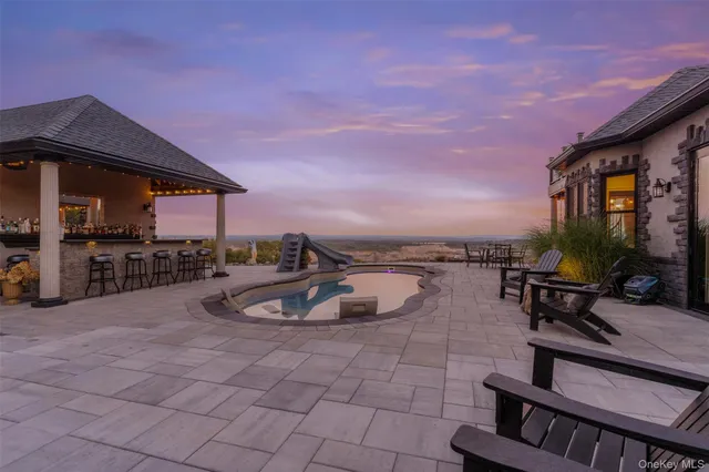 a view of a patio with a table and chairs