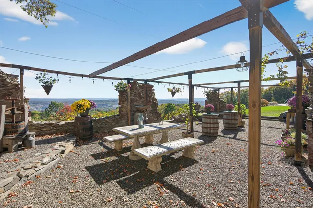 a view of a house with backyard porch and sitting area