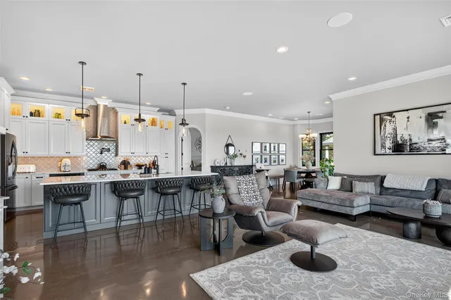 a living room with lots of furniture and kitchen view