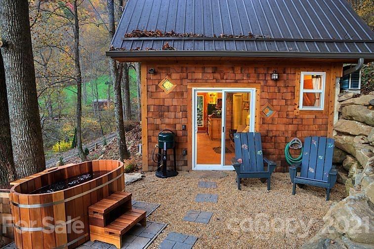 215 Meadow Branch Road Marshall, NC 28753 - Photo 17 of 32 a backyard of a house with barbeque oven table and chairs