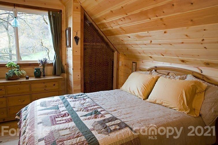 215 Meadow Branch Road Marshall, NC 28753 - Photo 21 of 32 a bedroom with a bed and window