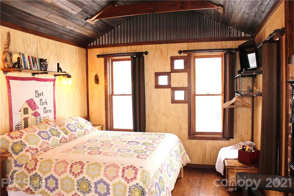 215 Meadow Branch Road Marshall, NC 28753 - Photo 28 of 32 a bedroom with furniture and a window