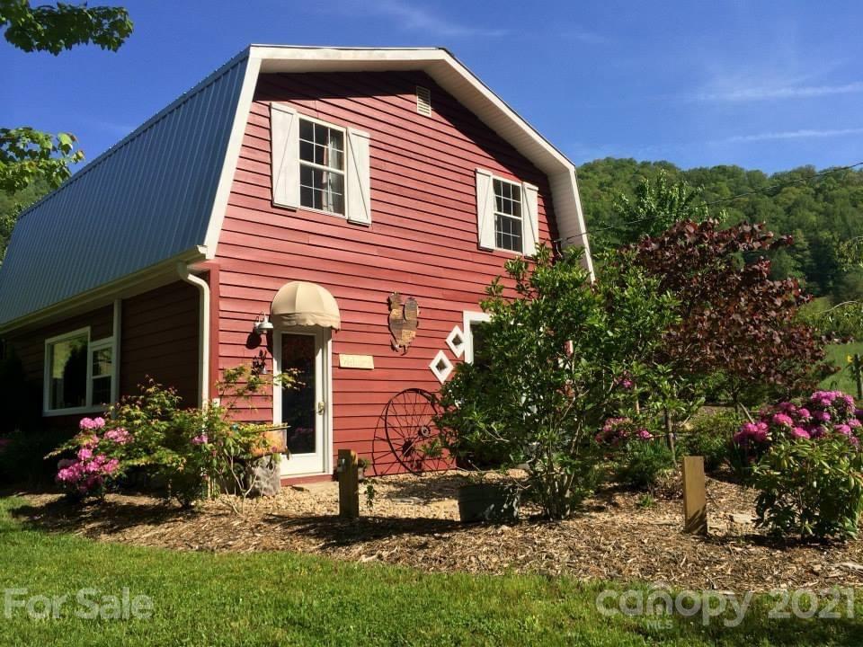 215 Meadow Branch Road Marshall, NC 28753 - Photo 7 of 32 a front view of a house with a yard