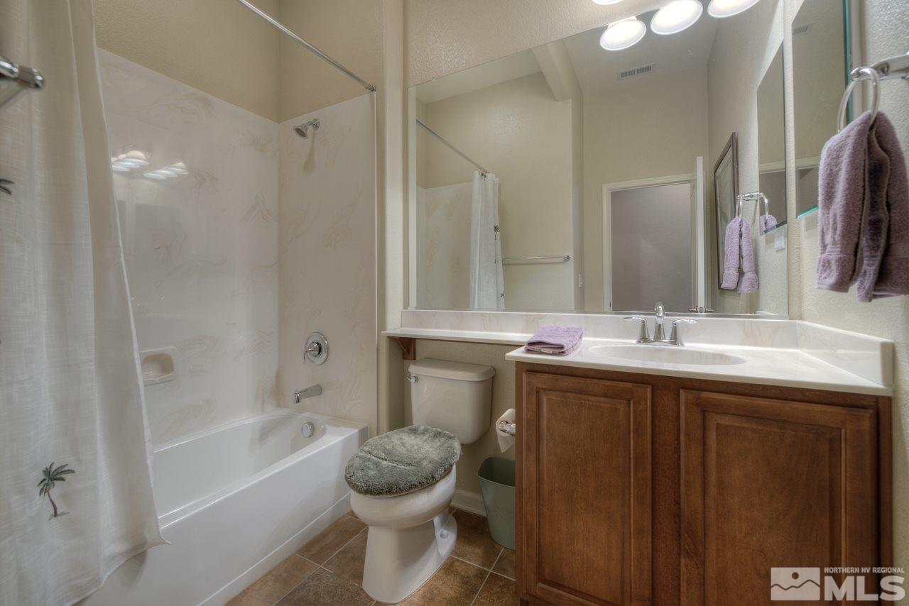 750 Sienna Station Way Reno, NV 89512 - Photo 16 of 21 a bathroom with a granite countertop sink toilet and shower
