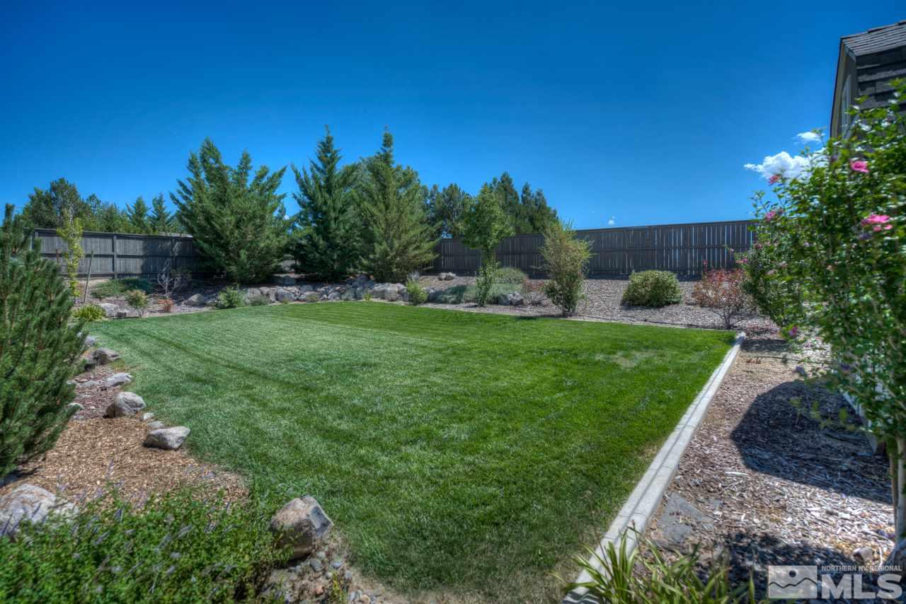 750 Sienna Station Way Reno, NV 89512 - Photo 19 of 21 a view of a backyard with large trees