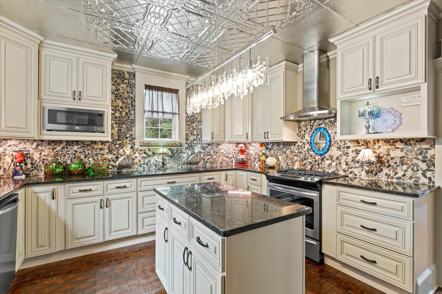 54 Plateau Avenue DeFuniak Springs, FL 32435 - Photo 25 of 114 a kitchen with granite countertop a sink stove and cabinets