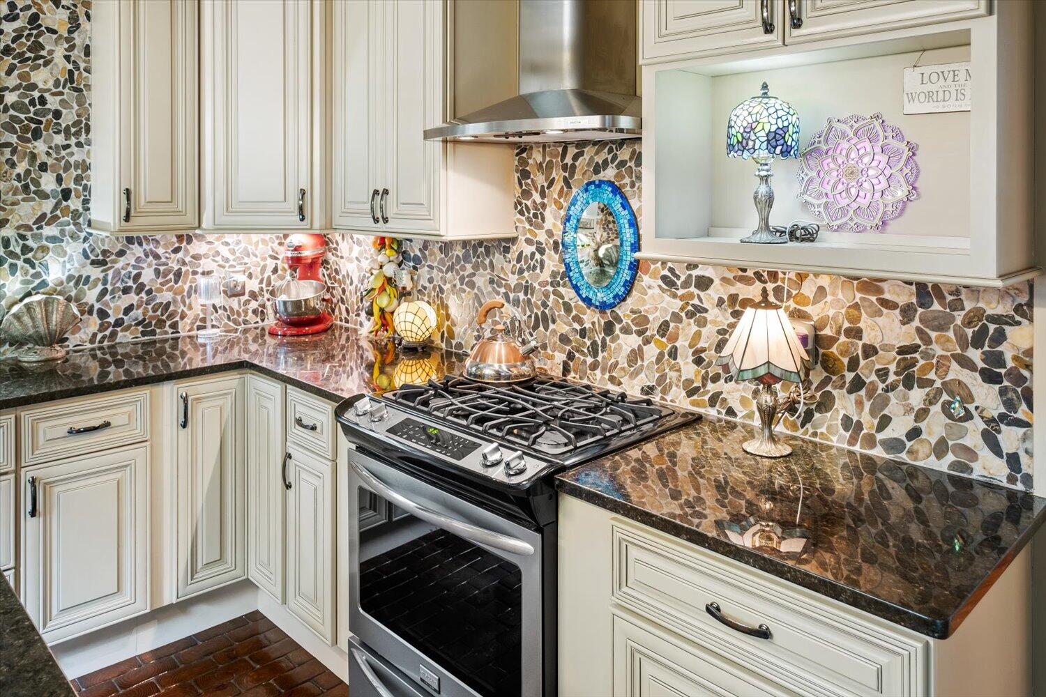 54 Plateau Avenue DeFuniak Springs, FL 32435 - Photo 26 of 114 a kitchen with stainless steel appliances granite countertop a stove a sink and a microwave