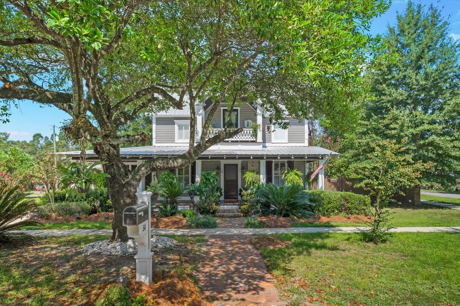 54 Plateau Avenue DeFuniak Springs, FL 32435 - Photo 4 of 114 a front view of a house with a garden