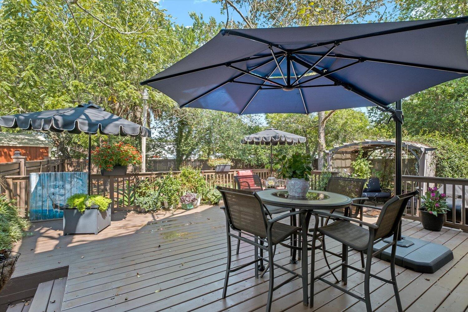 54 Plateau Avenue DeFuniak Springs, FL 32435 - Photo 60 of 114 a patio with wooden floor a yard a table and chairs