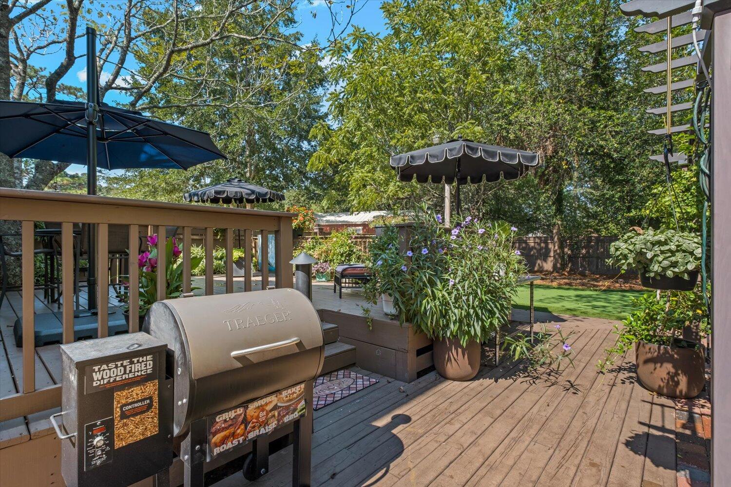 54 Plateau Avenue DeFuniak Springs, FL 32435 - Photo 63 of 114 a patio of a house with table and chairs under an umbrella