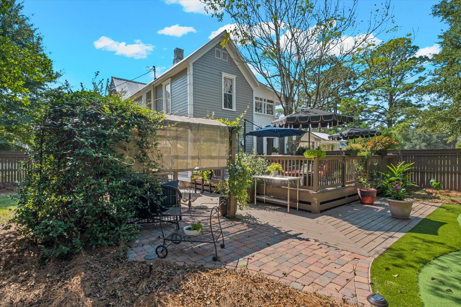 54 Plateau Avenue DeFuniak Springs, FL 32435 - Photo 65 of 114 a view of a patio with table and chairs with wooden fence and plants