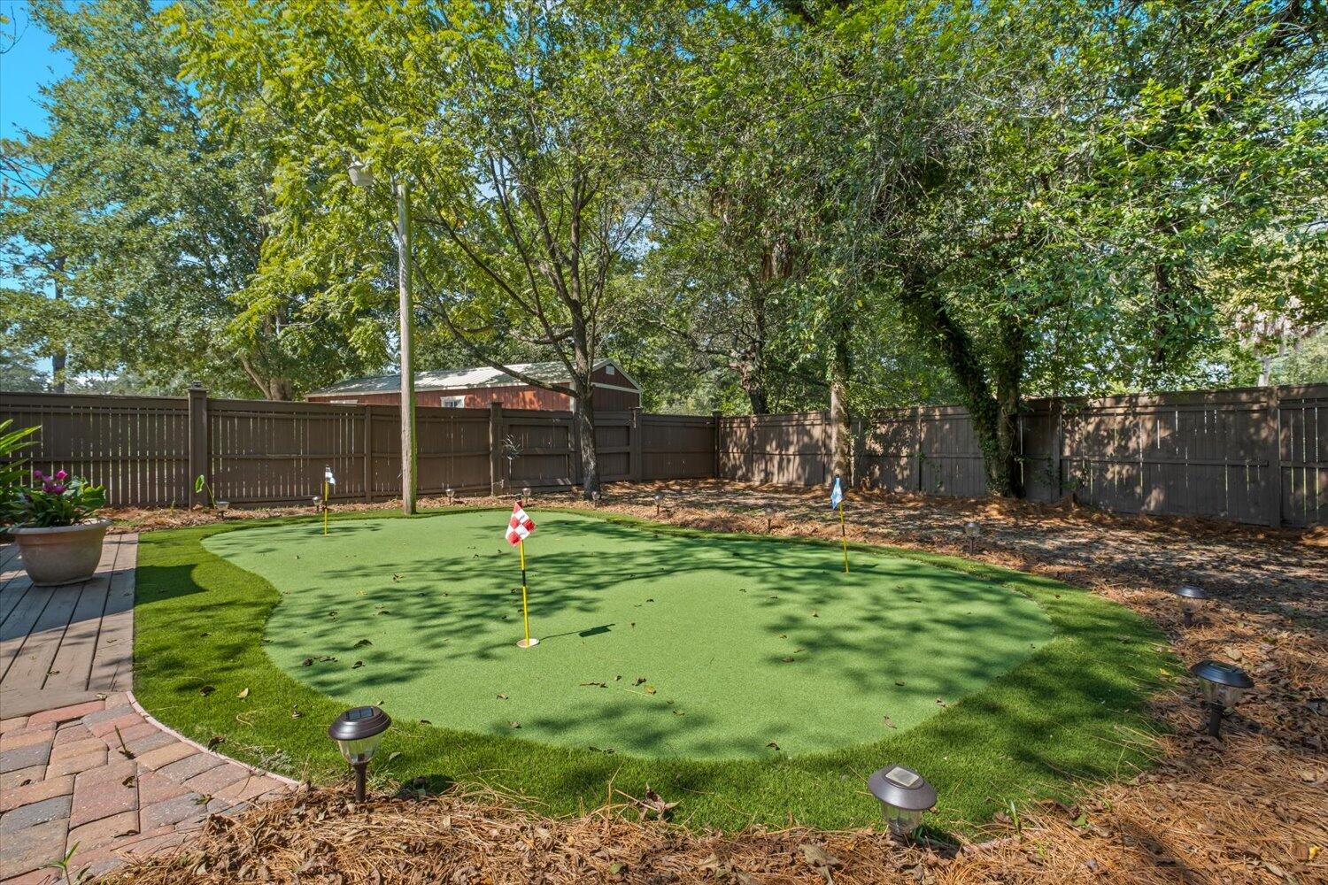 54 Plateau Avenue DeFuniak Springs, FL 32435 - Photo 66 of 114 a backyard of a house with table and chairs