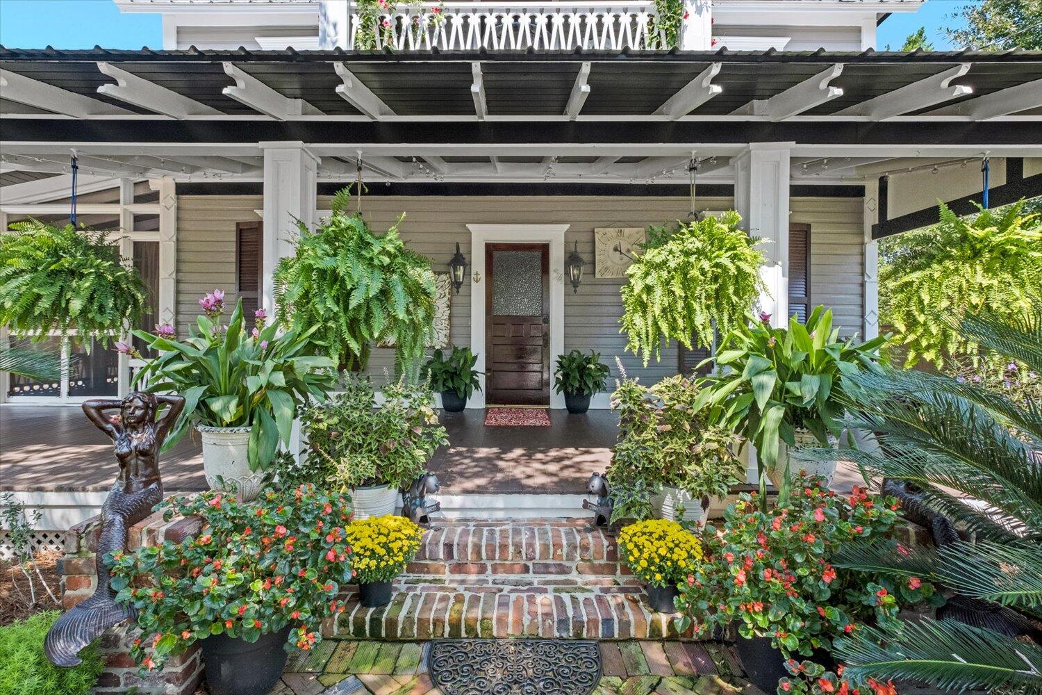 54 Plateau Avenue DeFuniak Springs, FL 32435 - Photo 7 of 114 front view of a house with a big yard and potted plants
