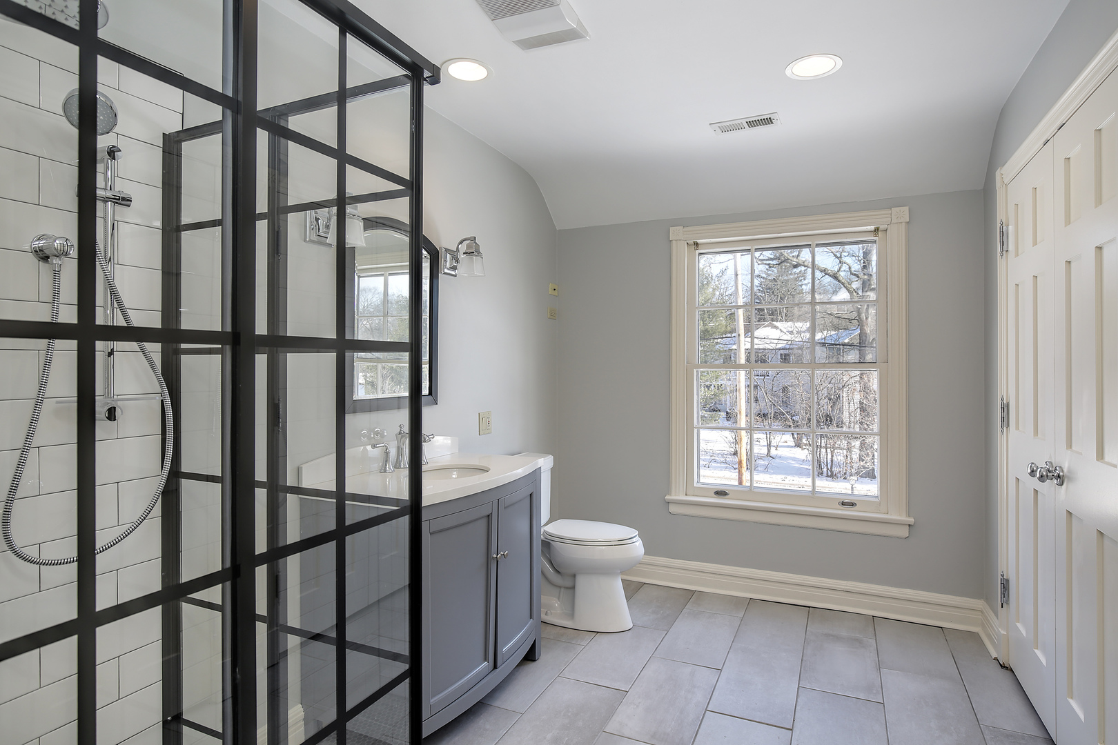 834 Valley Road Glencoe, IL 60022 - Photo 15 of 25 a bathroom with a toilet a sink and a window