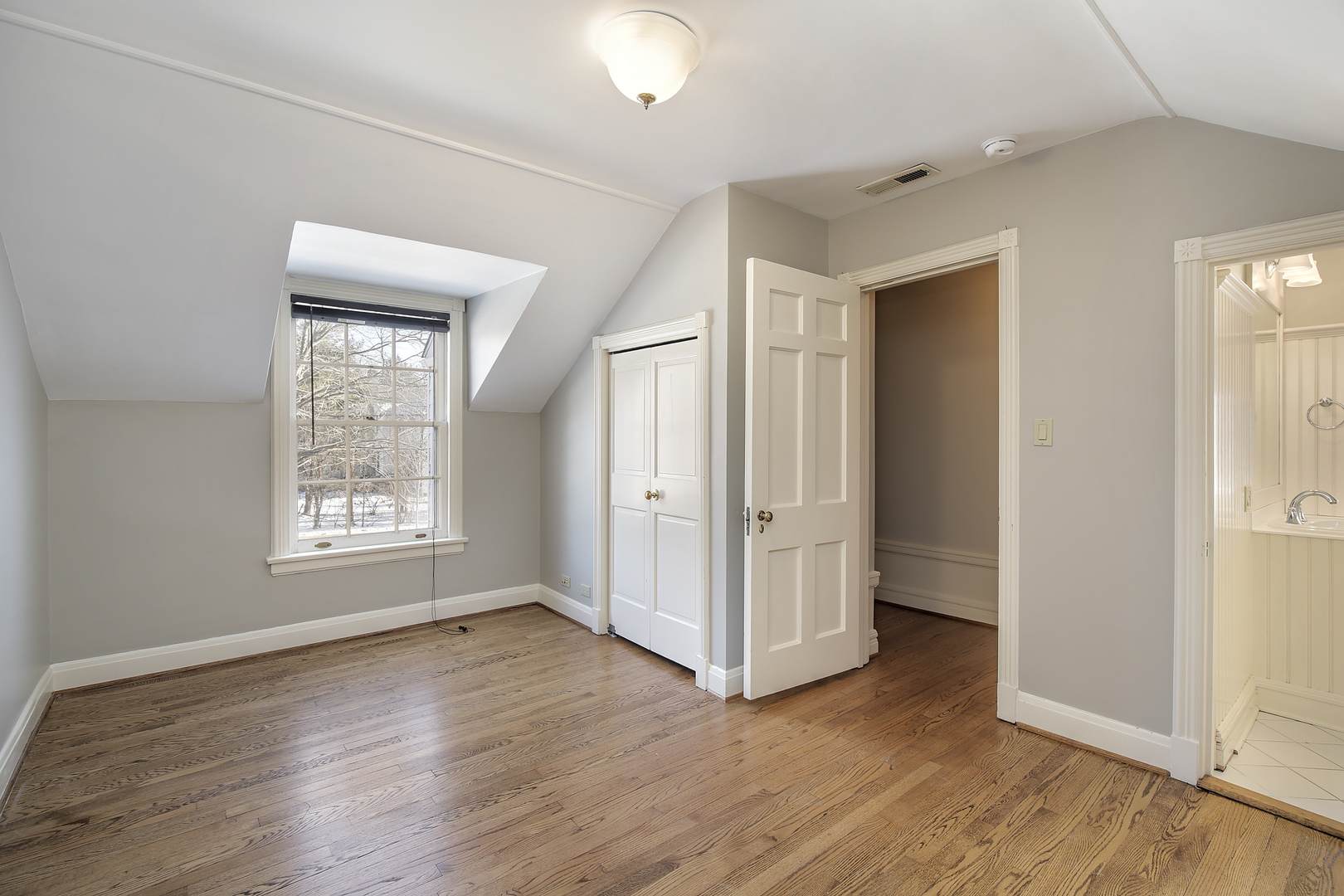834 Valley Road Glencoe, IL 60022 - Photo 21 of 25 an empty room with wooden floor and window