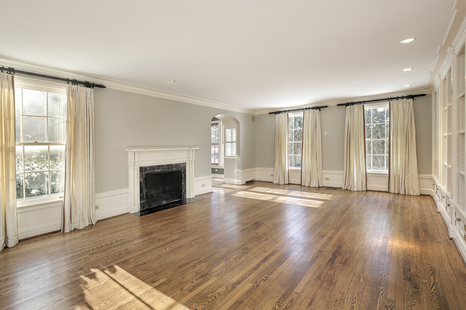 834 Valley Road Glencoe, IL 60022 - Photo 5 of 25 an empty room with wooden floor fireplace and windows