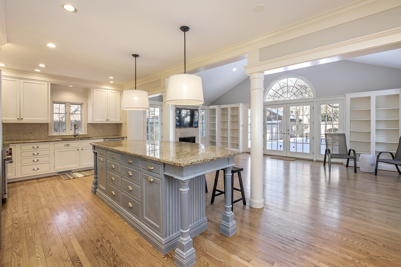 834 Valley Road Glencoe, IL 60022 - Photo 7 of 25 a kitchen with stainless steel appliances granite countertop a stove a refrigerator a kitchen island a island a sink cabinets and wooden floor