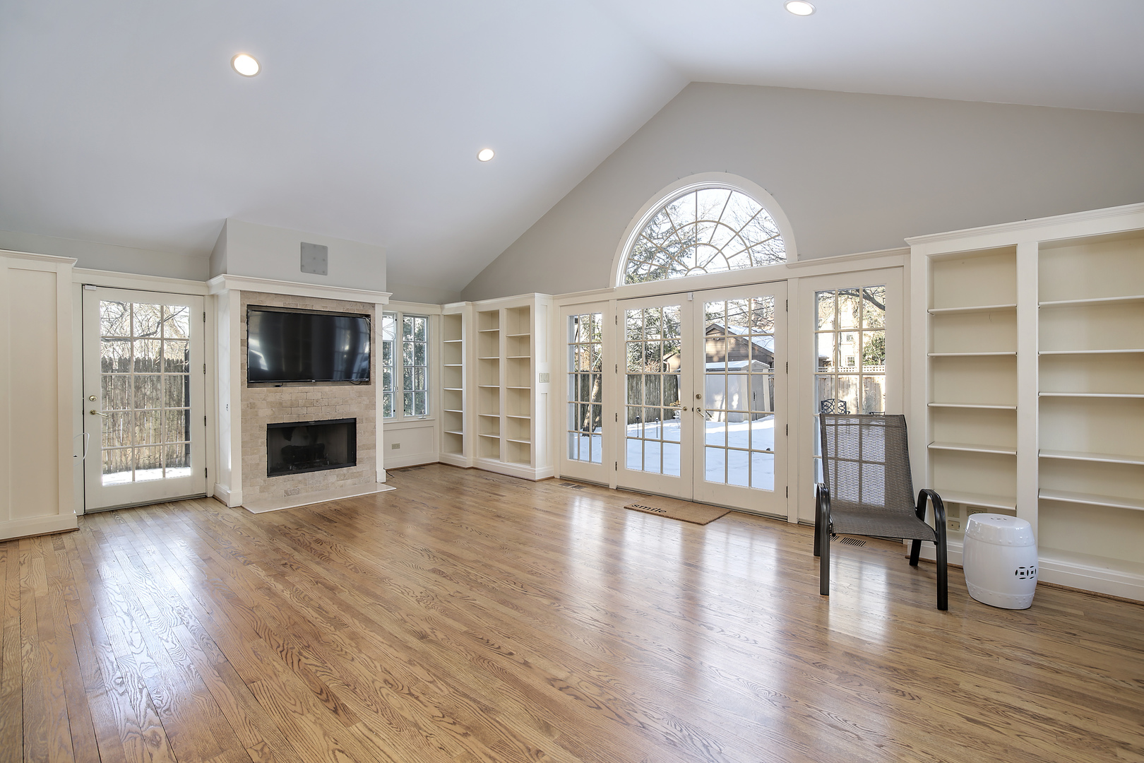 834 Valley Road Glencoe, IL 60022 - Photo 9 of 25 an empty room with wooden floor fireplace and windows