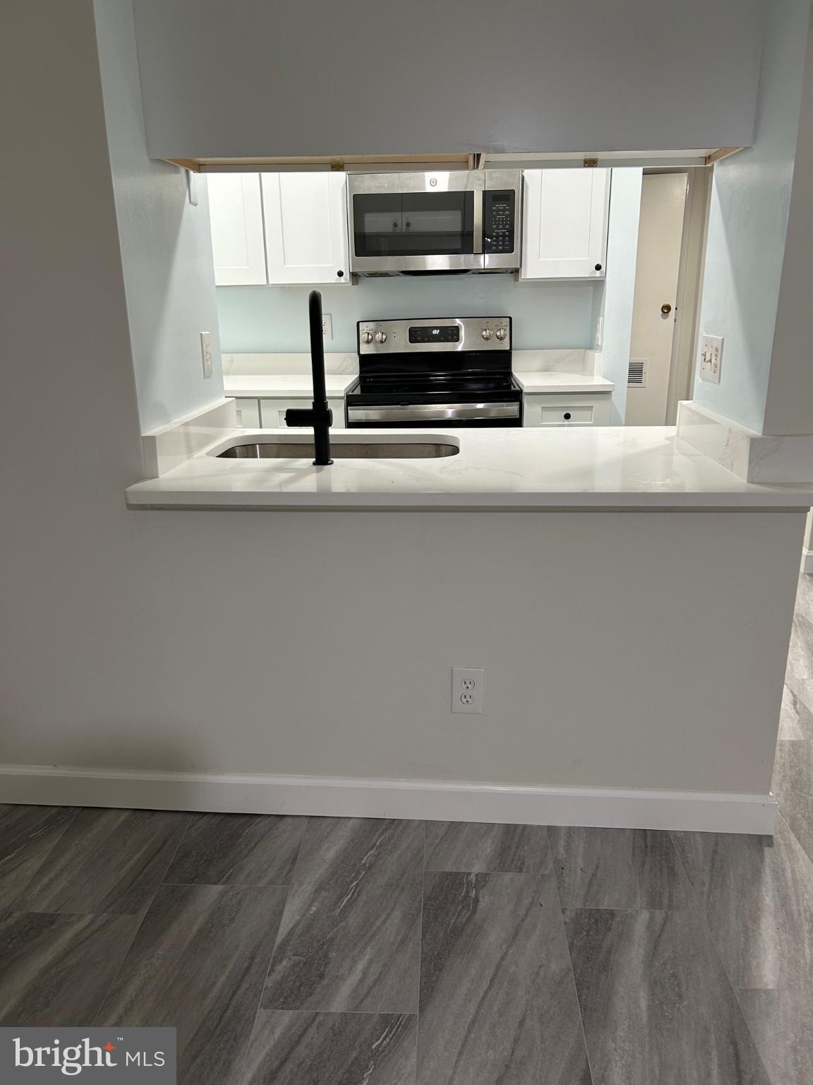 5823 Royal Ridge Drive, Unit D Springfield, VA 22152 - Photo 2 of 12 Modern kitchen with sleek finishes.