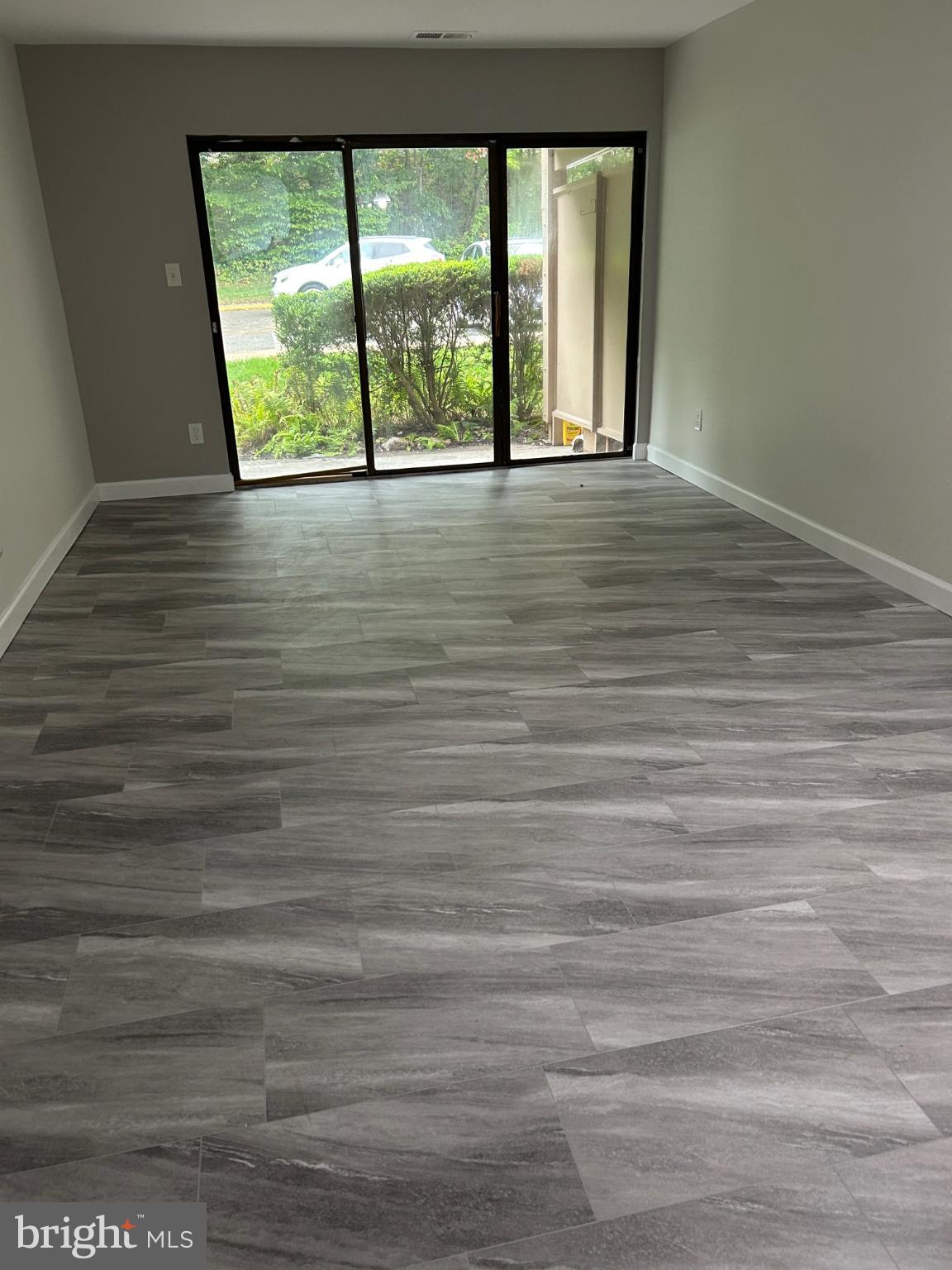 5823 Royal Ridge Drive, Unit D Springfield, VA 22152 - Photo 6 of 12 Spacious room with modern gray flooring.