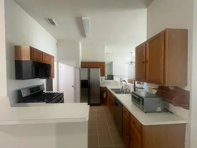 a kitchen with a sink stove and refrigerator