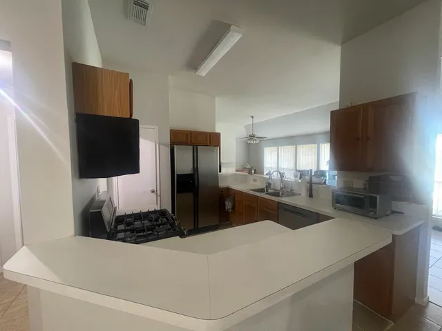 a kitchen with a refrigerator and a sink