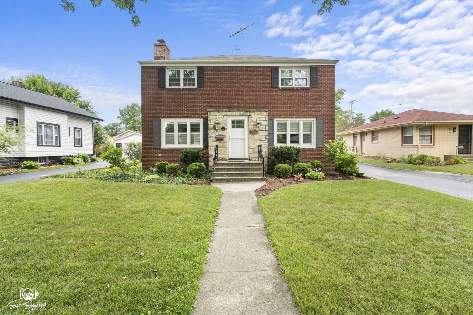 a front view of a house with garden