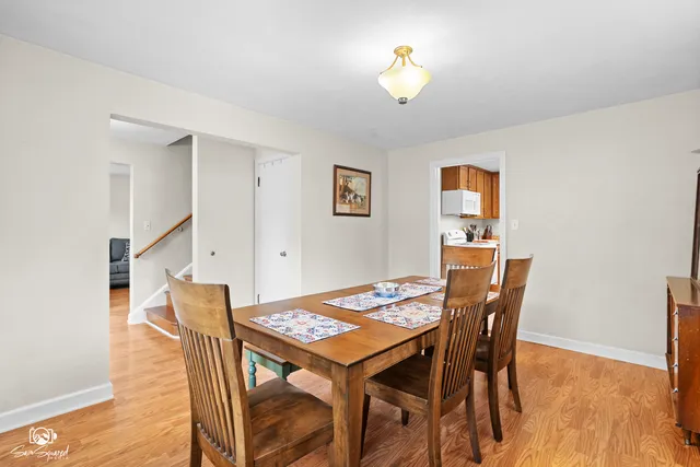 a view of a dining room with furniture and wooden floor