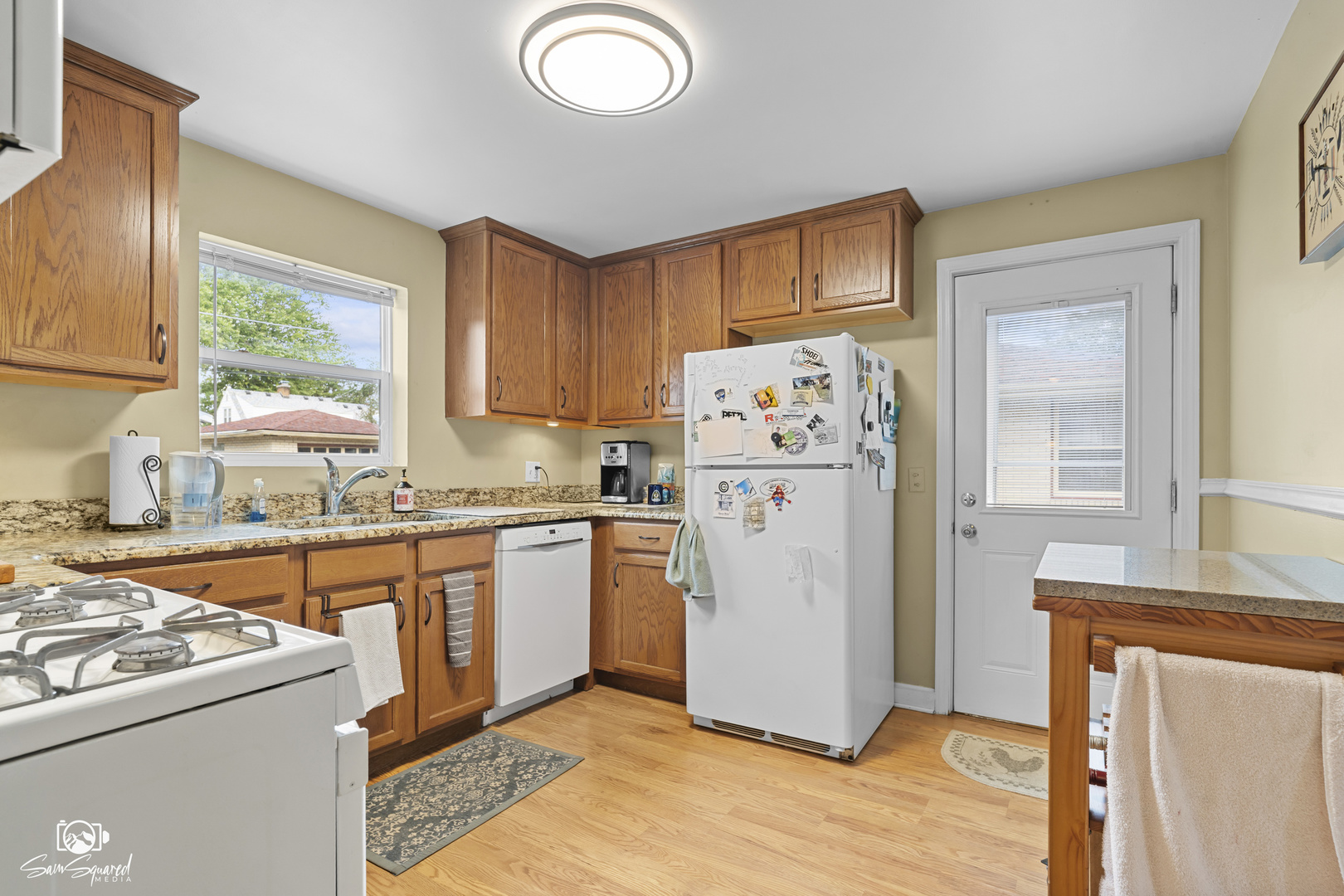 515 Cornelia Street Joliet, IL 60435 - Photo 17 of 28 a kitchen with a refrigerator a stove a sink dishwasher and wooden cabinets with wooden floor