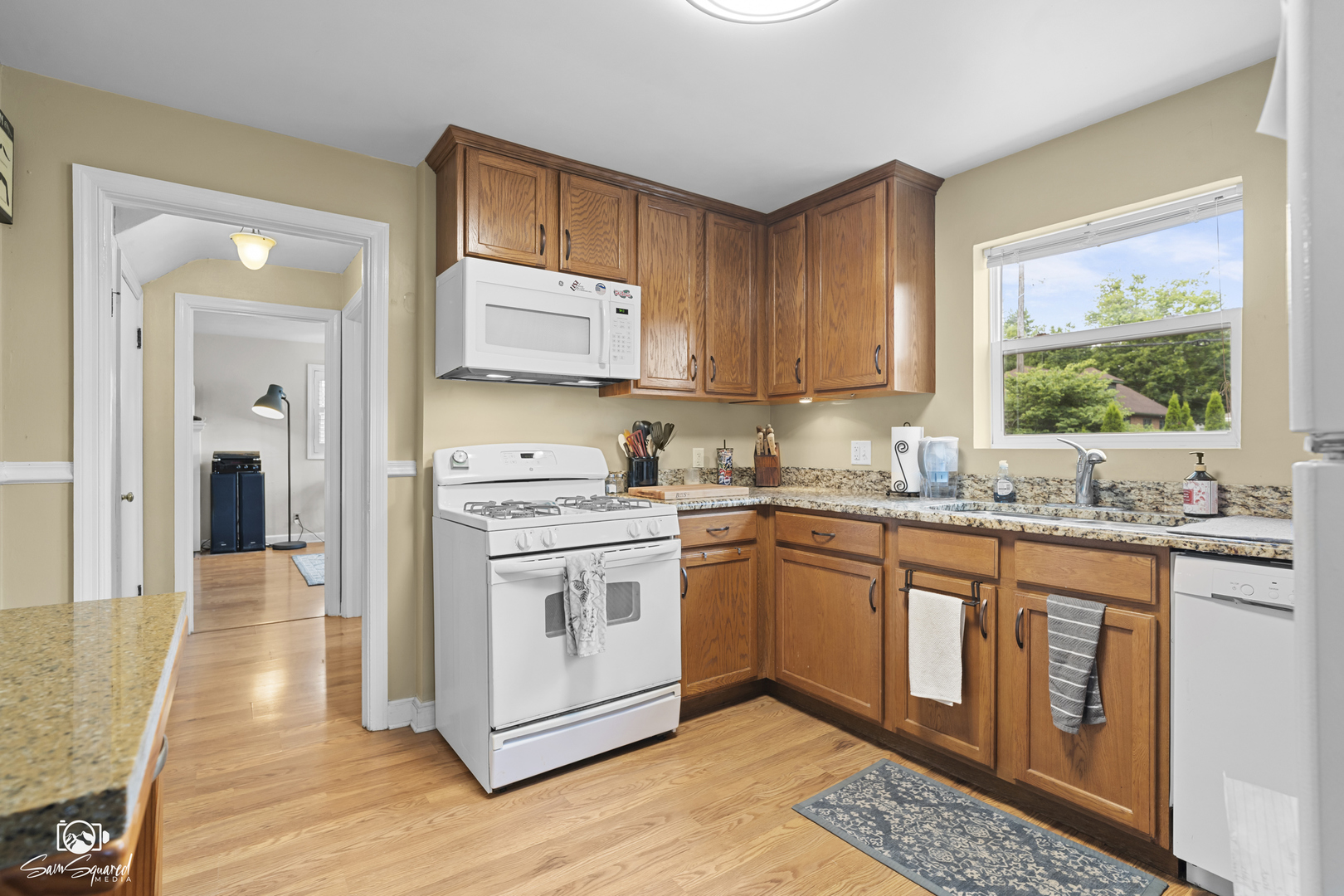 515 Cornelia Street Joliet, IL 60435 - Photo 18 of 28 a kitchen with stainless steel appliances granite countertop a stove a sink and a microwave