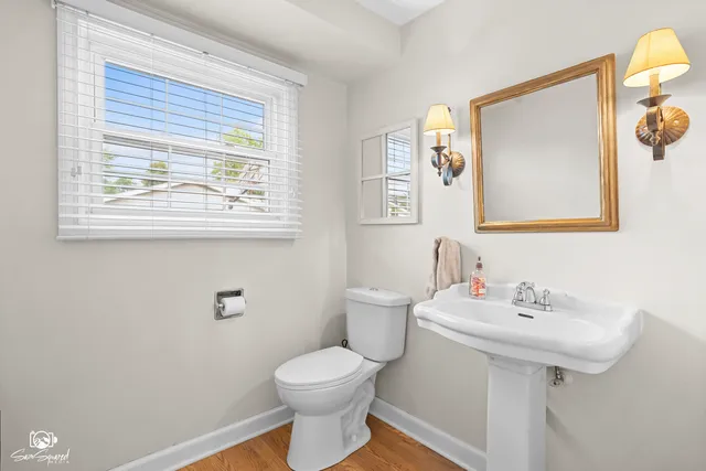a bathroom with a sink mirror and toilet