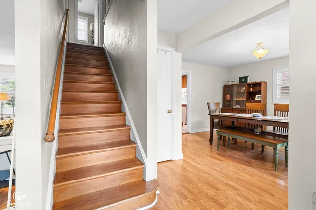 a view of a hallway with wooden floor and furniture