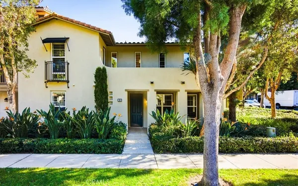 a front view of a house with a yard and swimming pool