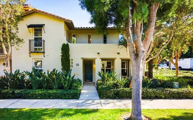 a front view of a house with a yard and swimming pool