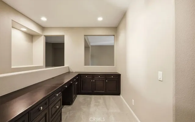 a large bathroom with a sink a vanity and a mirror