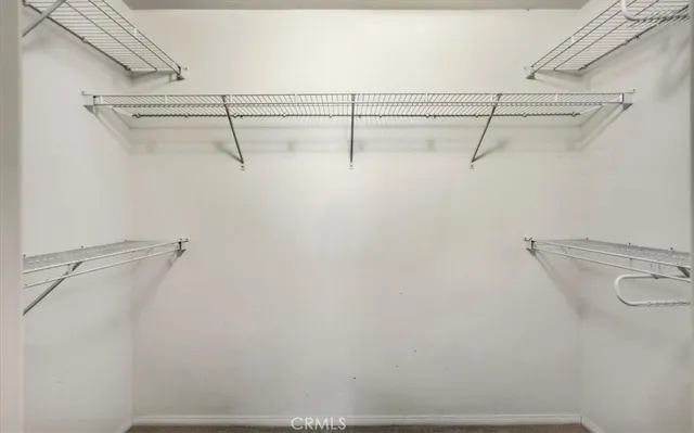 a view of a room with wooden floor and a potted plant