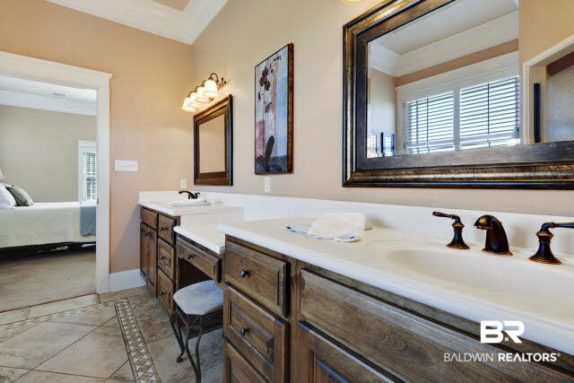 17140 Davis Road Summerdale, AL 36580 - Photo 19 of 33 Master bath has two sinks and a makeup area on the vanity. Tub, shower, linen closet and toilet room complete the bath.